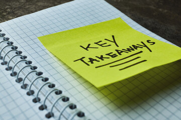 Key takeaways written on a bright sticky note
