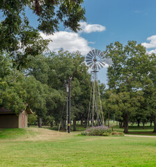 old windmill in the countryside next to small building