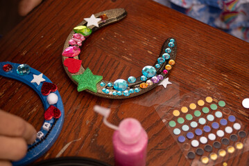 Unique kid's horseshoe craft decorated with sparkles, stickers and gems