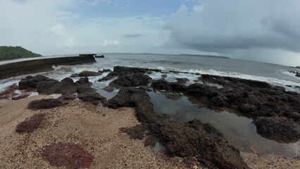 Scenic Ocean Shoreline with Rocks and Tide Pools on a Cloudy Day