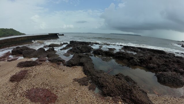 Scenic Ocean Shoreline with Rocks and Tide Pools on a Cloudy Day