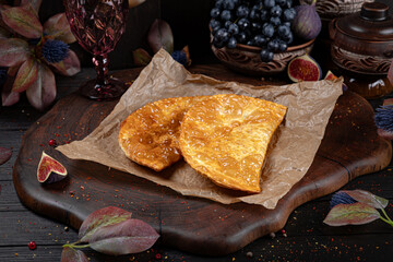 Crispy golden chebureki, traditional deep-fried pastries filled with juicy minced meat. Traditional Georgian Bread. Traditional Georgian cuisine styled with authentic atmosphere.