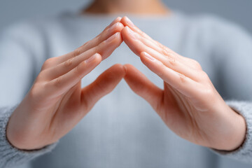 Pair of human hands forming a dome shape, symbolizing protection, care, and mental health support.