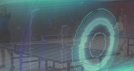 Female players serving and rallying for drills with animated turquoise rings on table tennis table