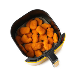 Air fryer basket with chicken nuggets isolated on white, top view