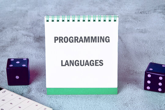 Business, programming, interface, application and network concept. Text PROGRAMMING LANGUAGES on an upright notepad