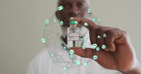 Male researcher raising vaccine vial, forming rotating digital network icons showing health data - Powered by Adobe
