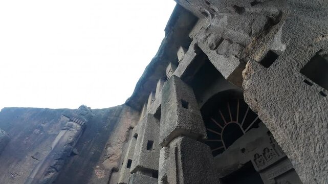 Dramatic Exterior View of the Grand Rock-Cut Buddhist Chaitya Hall Entrance (Cave 3) at Kanheri, Mumbai, Under an Overcast and Cloudy Sky