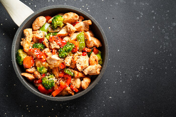 Chicken stir fry with vegetables and sesame.