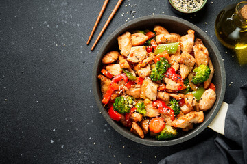 Chicken stir fry with vegetables and sesame.