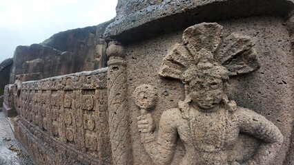 The Rich Texture and Fine Craftsmanship of Ancient Rock-Cut Reliefs Adorning a Wall in the Kanheri Cave Complex, Evoking Spiritual Heritage.