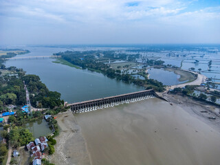 Aerial view of a water barrage with open gates and flowing water. 
The Muhuri Project, officially known as the Muhuri Irrigation Project (MIP), is a major water resource initiative in Bangladesh.