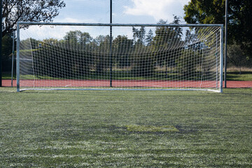 Goal with net on a football field, sport.
