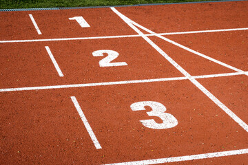 Start and numbers on the stadium track, running, sports.

