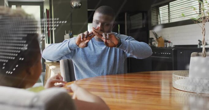 Man giving thumbs-up and guiding child framing hands as code-and-map illustrating coding lesson