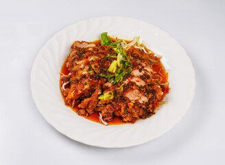 Spicy Fried Chicken Cutlet with Chili Garlic Sauce, Scallions, and Salad Garnish on a White Plate top view of japanese food