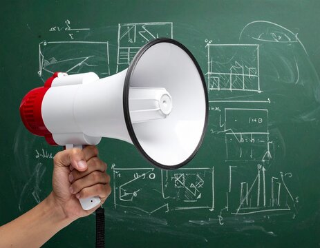 Hand Holding a Red and White Megaphone Against a Chalkboard with Diagrams