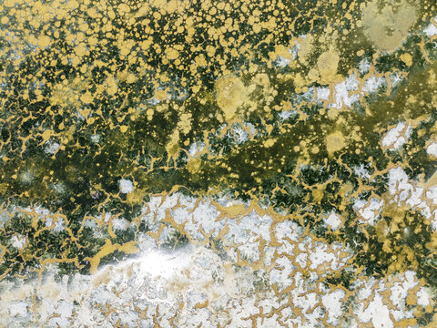 Aerial view of shimmering saline ponds painted in earthy hues, reflecting sunlight like scattered jewels across the landscape, Bay of C&Atilde;&iexcl;diz, C&Atilde;&iexcl;diz province, Andalusia, Spain.