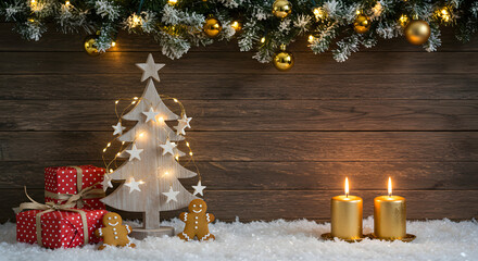 Festive Christmas scene with a wooden background, decorated tree, gifts, gingerbread men, and two lit golden candles on a snowy surface.