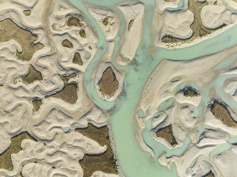 Aerial view of turquoise waters carve intricate paths through the sandy landscape, creating a mesmerizing tapestry of textures and tones, Bay of C&Atilde;&iexcl;diz, C&Atilde;&iexcl;diz province, Andalusia, Spain.