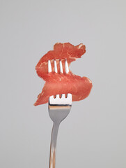 Slice of bresaola beef at the fork