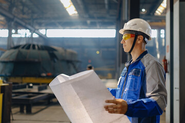 Male industrial engineers control at project with blueprints in industry factory heavy manufacturing shipyard