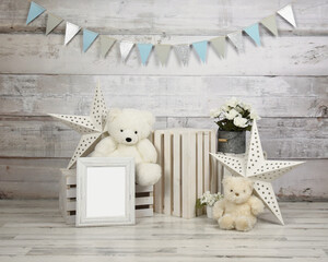 A studio scene of teddy bears with a party banner and a blank frame for a text message for a baby first birthday studio backdrop.