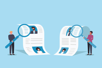 Two people using magnifying glasses to review resumes and candidate profiles for hiring and recruitment