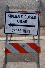 SIDEWALK CLOSED sign at a road construction site