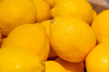 Lot of bright yellow lemons in supermarket