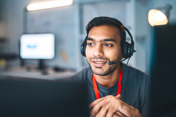 Portrait young adult indian man wearing headset remote work online technical support business customer service at home