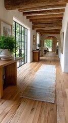 Sunlight streams through large windows illuminating a refined hallway with wood flooring, area rug, and chic planters