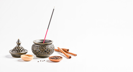Incense burner with Arabic design and incense sticks on white background - Ramadan poster with copy space  
