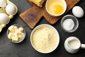 Cornbread preparation. Different ingredients on black textured table, flat lay