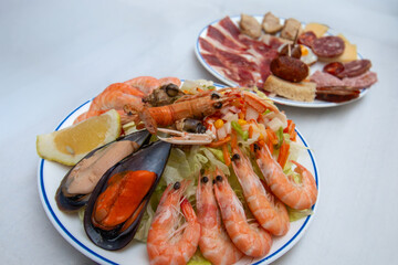 Spain - Exquisite seafood platter of prawns, mussels, and langoustine, with charcuterie.