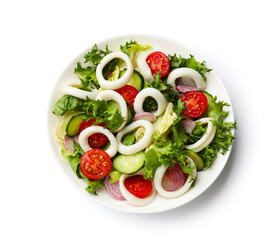 Delicious salad with squid rings and vegetables isolated on white, top view