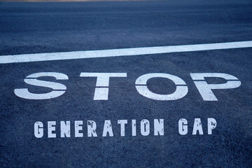 stop generation gap. words painted on the asphalt at a traffic sign