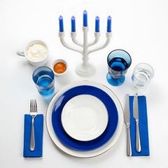 Decorative Hanukkah table setting with blue candles and dishes  