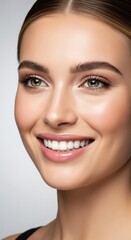 Beautiful woman portrait with perfect skin, radiant smile, white teeth, natural makeup and glowing complexion close-up