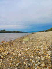 Pebble Shoreline with Distant Mountains on the Danube