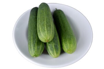 Fresh cucumber is displayed in white plate, radiating vitality and healthy vibes, ideal for culinary or wellness related visuals