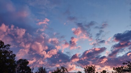 Vibrant Sunset Sky with Colorful Clouds and Silhouetted Trees