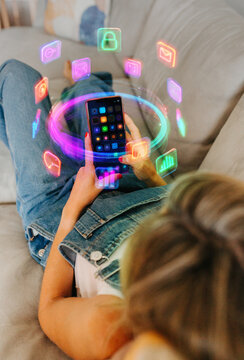 Relaxed woman browsing colorful digital apps on smartphone at home