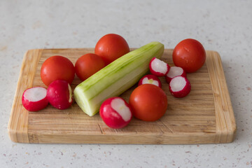 Vegetable garnish in the kitchen. Cucumber, radish, tomato, bell pepper