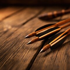 Close-up of traditional wooden arrows with feather fletching resting on a rustic wooden surface