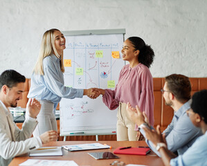 Group of young business people having a meeting shaking hands handshake introducing each other, introduction of a new colleague emplyee in the office
