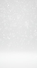 Snowfall in soft focus on white background during winter season  