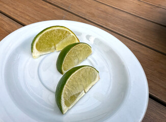 Citrus lime fruit segments on a white plate