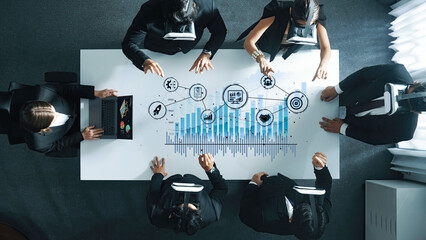 A diverse business team utilizes virtual reality technology during a meeting, interacting with data visualizations and graphs to analyze market trends and develop strategies. Trope