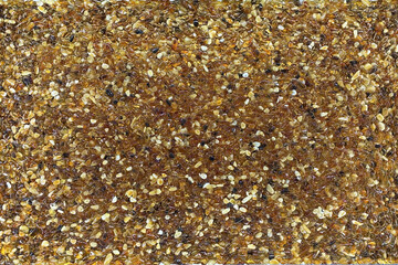 Baltic amber, close-up textured background. Orange, brown and yellow natural mineral, golden raw jewelry material